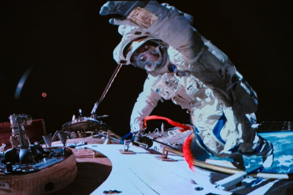 Shenzhou-19 astronaut Song Lingdong waves during the record-breaking nine-hour spacewalk in a screen image captured at the Beijing Aerospace Control Centre on Tuesday. Photo: Xinhua