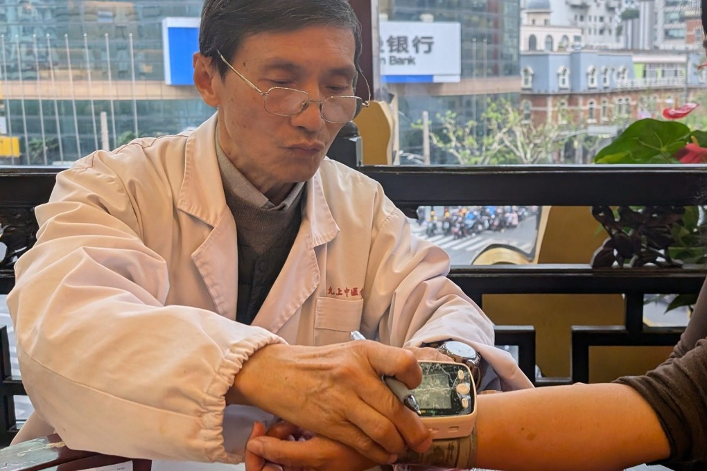 Qiu Jingchuan, deputy chief practitioner at Lei Yun Shang, takes a patient’s blood pressure at the company’s TCM clinic in Shanghai, China. Photo: Lisa Cam