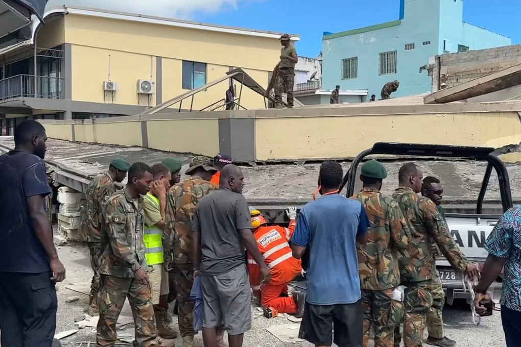 Rescuers inspect a collapsed building in Vanuatu’s capital Port Vila after a powerful earthquake hit the Pacific nation. Photo: Michael Thompson via AFP