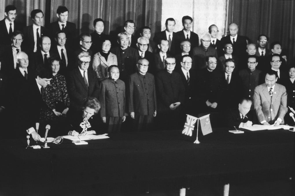 In Beijing, the British Prime Minister Margaret Thatcher, and the Chinese Prime Minister Zhao Ziyang, sign the Sino-British Joint Declaration on December 19, 1984, while officials from both sides look on. Photo: SCMP