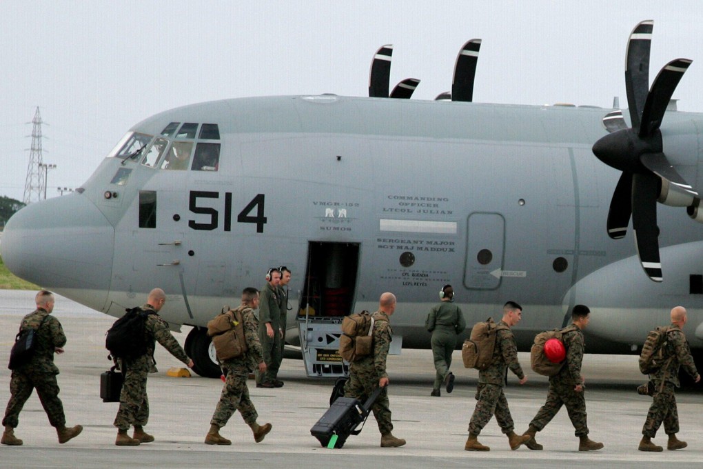 Japan-based US Marine Corps soldiers embark an aircraft in Ginowan, Okinawa Prefecture, southern Japan, in November 2013. Photo: EPA