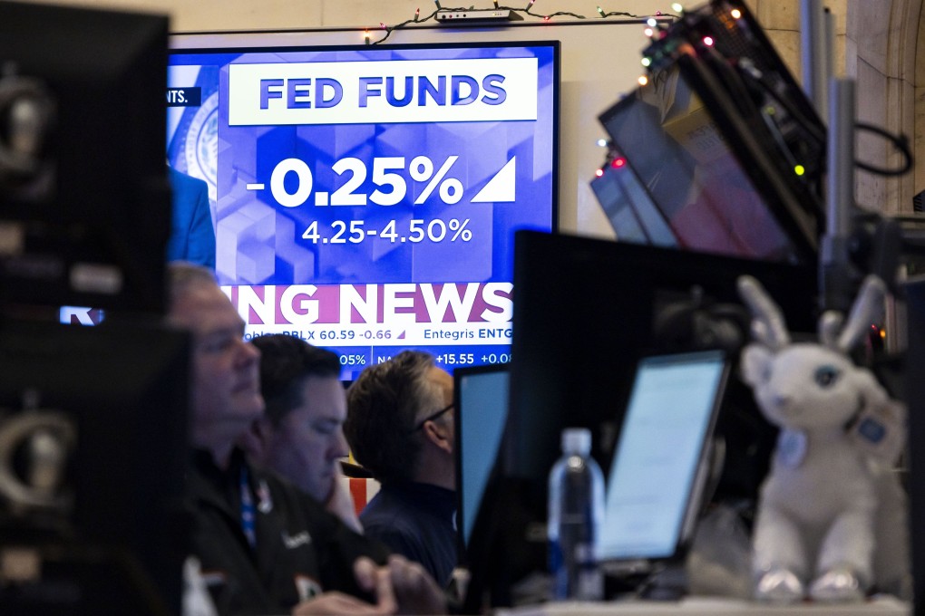 News of the US Federal Reserve’s move to cut its benchmark lending rate by 25 basis points flashes on a television screen as traders work at the New York Stock Exchange. Photo: EPA-EFE