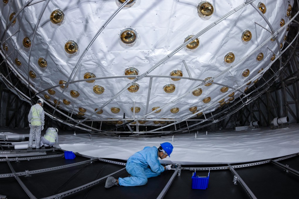 Staff seal the bottom of a water tank with Tyvek material at the Juno construction site in southern China. Juno is expected to operate for at least 30 years. Photo: Xinhua