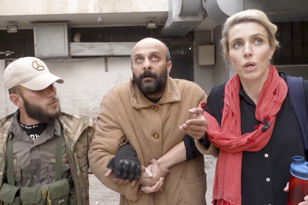 Reporter Clarissa Ward and a man who was freed after she and a Syrian rebel guard discovered him locked in a Damascus prison. Photo: CNN via AP
