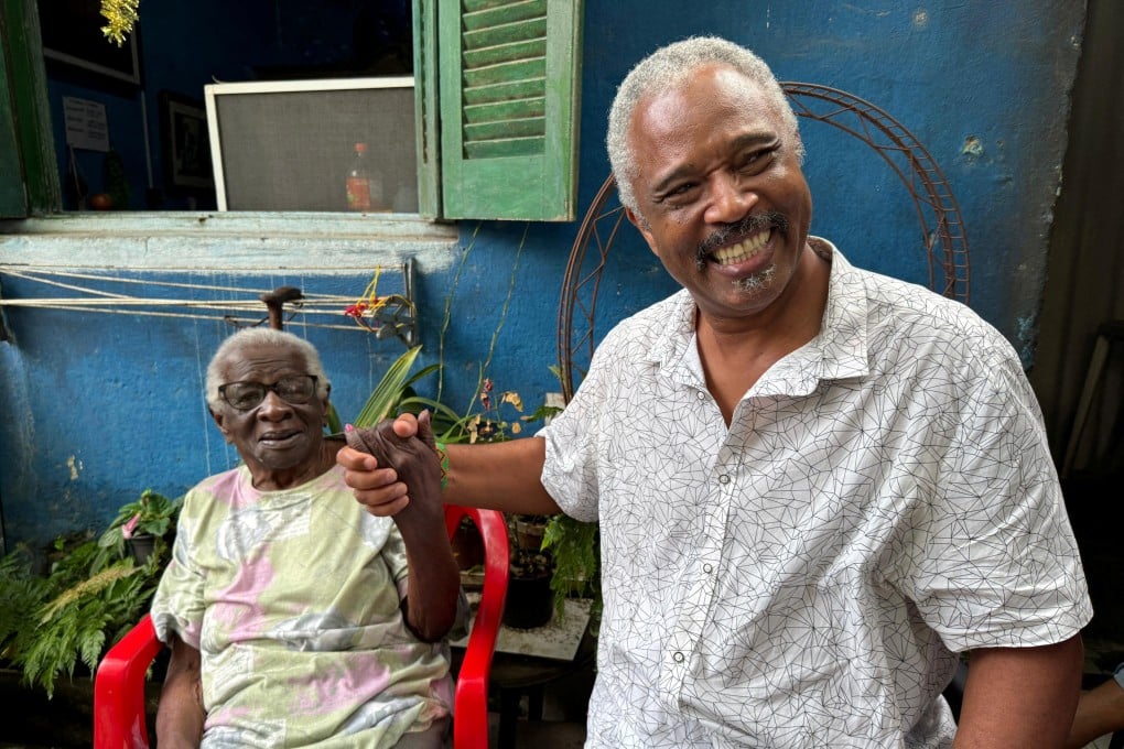 Helena da Costa, 99, whose father was forcibly taken to Brazil from Africa in the 1800s, hopes to be on the cruise Dagoberto Jose Fonseca (right) is organising. Photo: Reuters