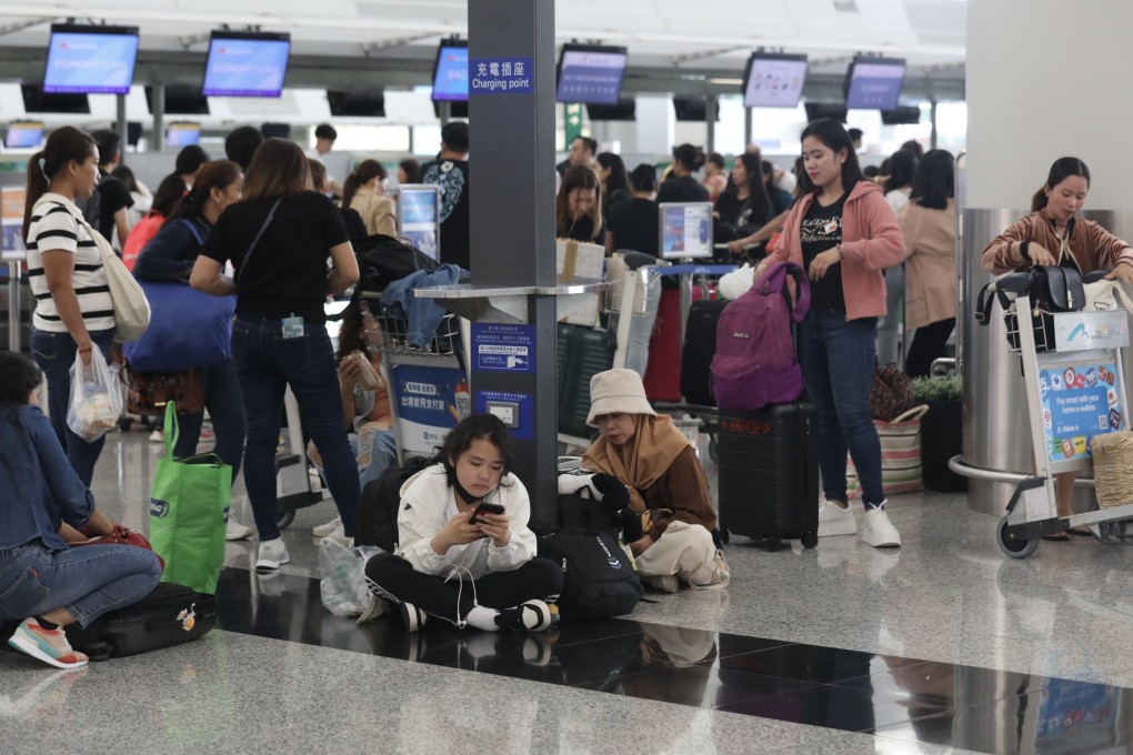 Passengers at Hong Kong International Airport on July 20, a day after a global IT service shortage affected air travel. Cybersecurity threats and extreme weather events are among the global risks that could become more severe in the coming years, contributing to financial woes across borders. Photo: Xiaomei Chen