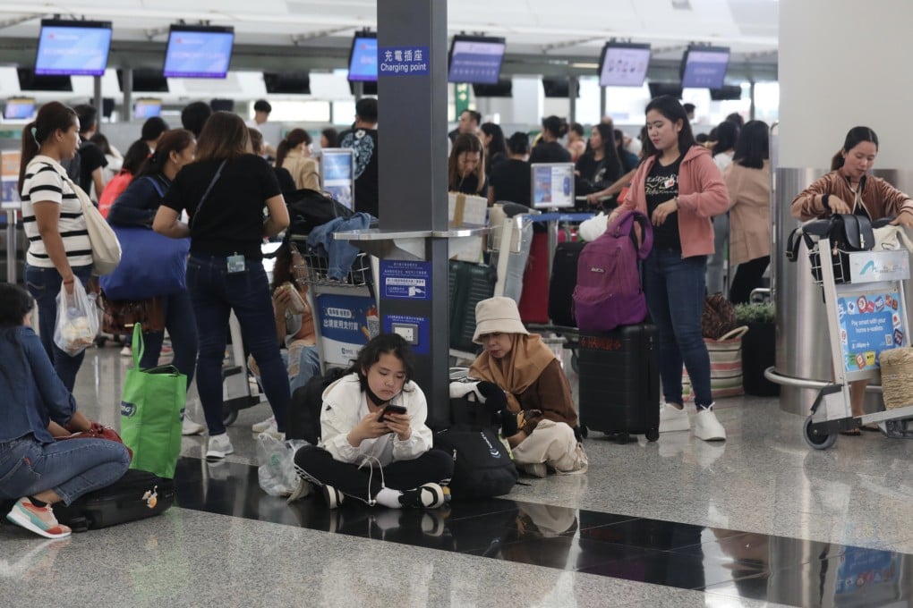 Passengers at Hong Kong International Airport on July 20, a day after a global IT service shortage affected air travel. Cybersecurity threats and extreme weather events are among the global risks that could become more severe in the coming years, contributing to financial woes across borders. Photo: Xiaomei Chen