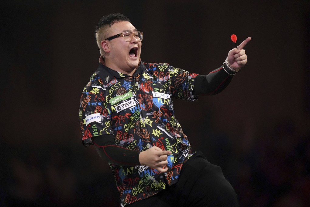 Hong Kong’s Lee Lok-yin celebrates winning his first round match against Chris Landman on day five of the Paddy Power World Darts Championship. Photo: AP