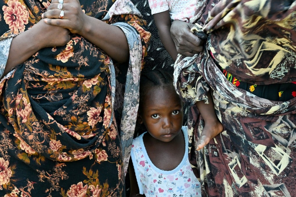 A child stands between two women at a school turned into a shelter, in Port Sudan, Sudan, in August. Millions of people in the region do not have enough food. Photo: Reuters