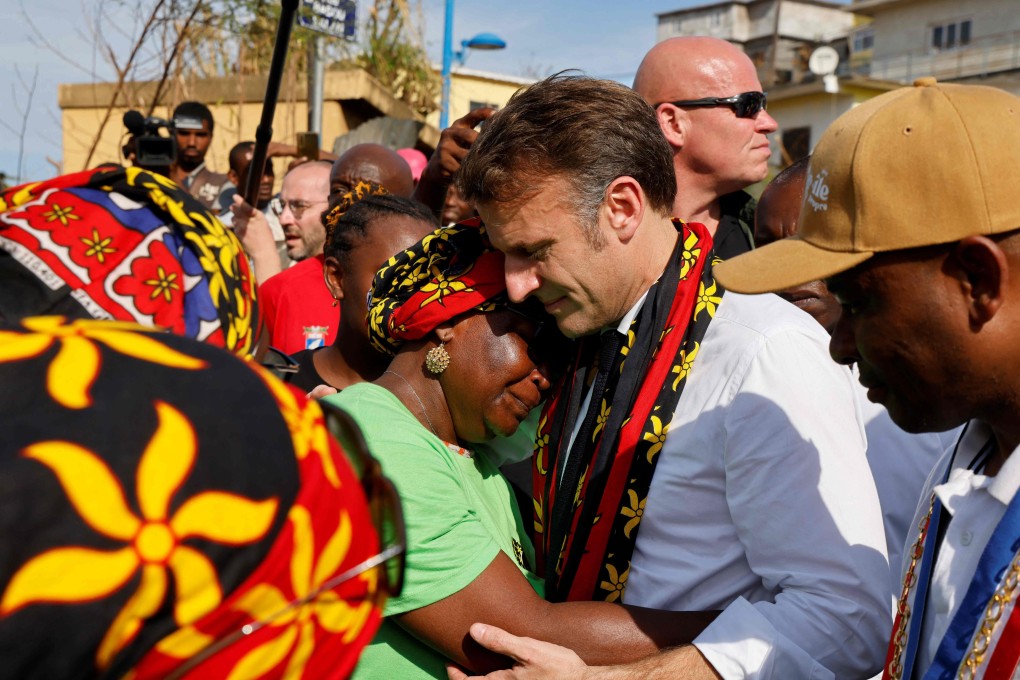 France’s President Emmanuel Macron embraces a woman during his visit to Mayotte following the cyclone. Photo: AFP