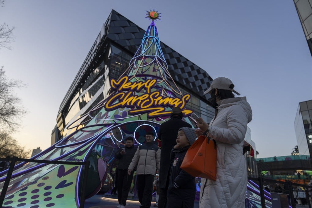 Visitors at a shopping centre in Beijing on Sunday. Photo: AP Photo