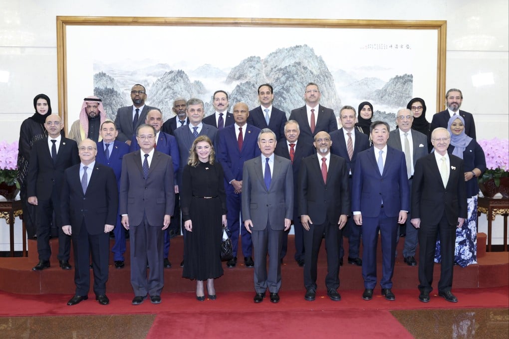 Chinese Foreign Minister Wang Yi (front row, centre) with diplomats from several Arab nations in Beijing on Thursday. Photo: EPA-EFE