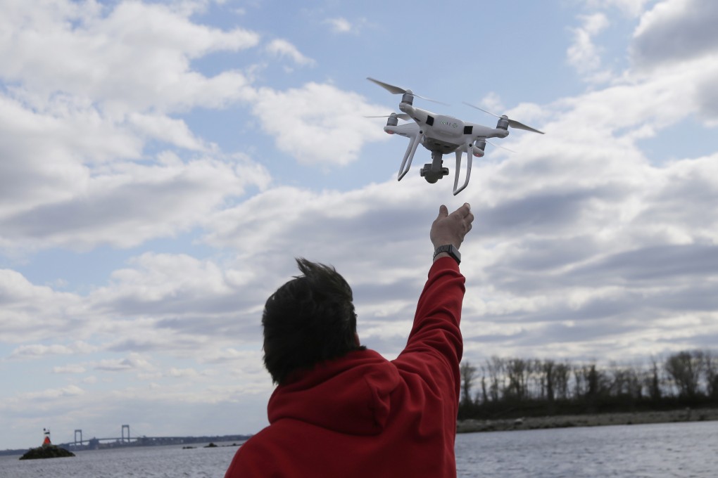 A drone operator retrieves a drone after photographing over Hart Island in New York in April 2018. Photo: AP