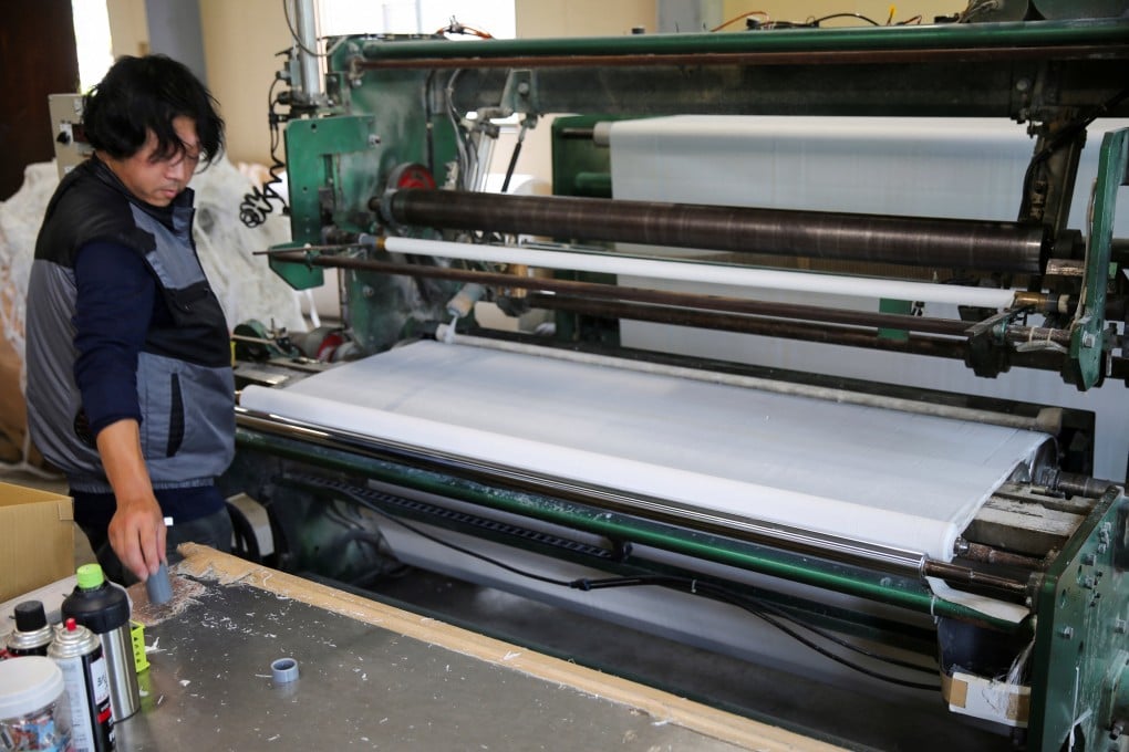 A worker prepares rolls of toilet paper at the Maruhide Seishi factory in Ino, Japan’s Kochi prefecture. Photo: Reuters