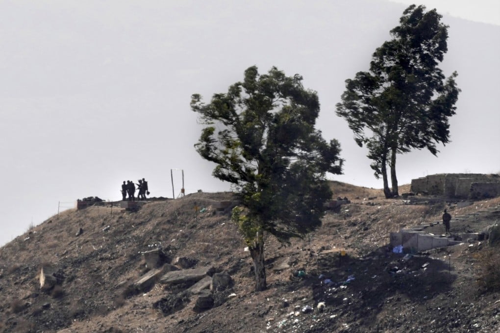Israeli soldiers take position at an abandoned Syrian military base near the border with Israel on Thursday. Photo: AP
