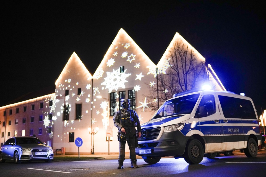 A police officer guards a blocked road near a Christmas market after an incident in Magdeburg, Germany, on Friday. Photo: AP