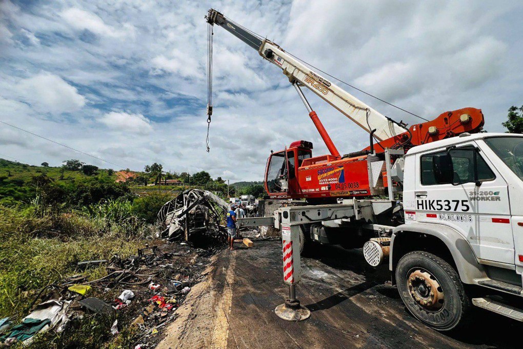 A crane works on the site of a crash in Teofilo Otoni, Minas Gerais state in Brazil. Photo: AFP/Minas Gerais Fire Department