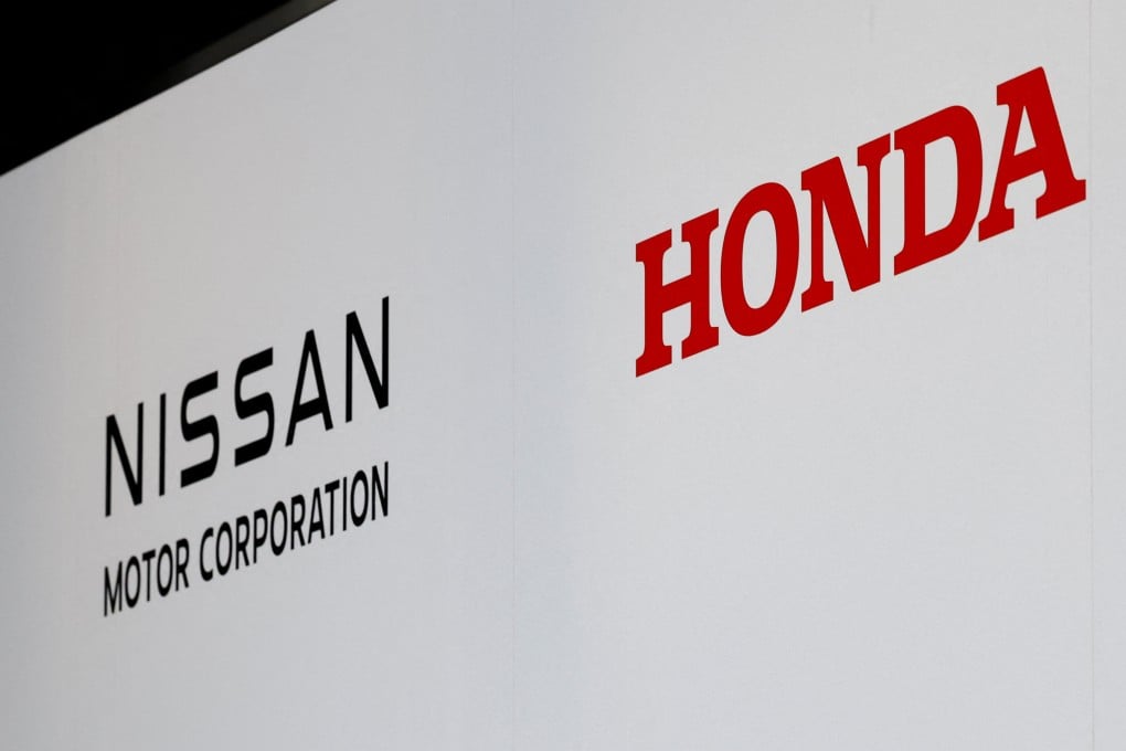 Logos of Nissan Motor Corporation and Honda are seen at a joint press conference on their merger talks, in Tokyo, Japan on December 23. Photo: Reuters