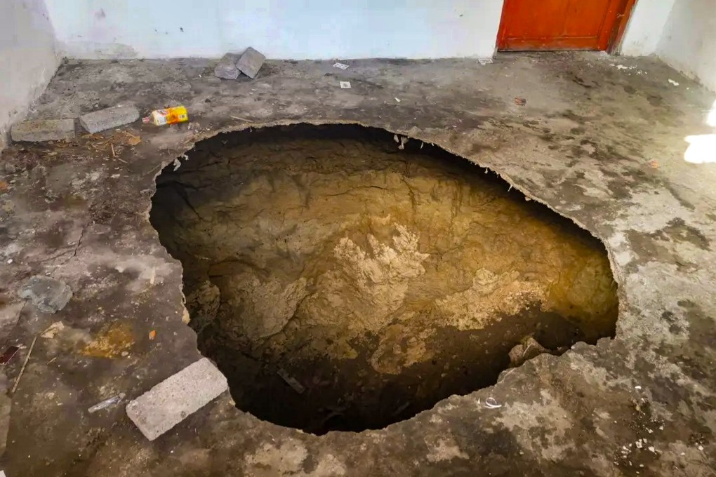 The gaping sinkhole that appeared in the middle of Hu Yuzhen’s kitchen floor in a village in Guizou province, southwest China on December 9. Photo: Weibo / 红星新闻