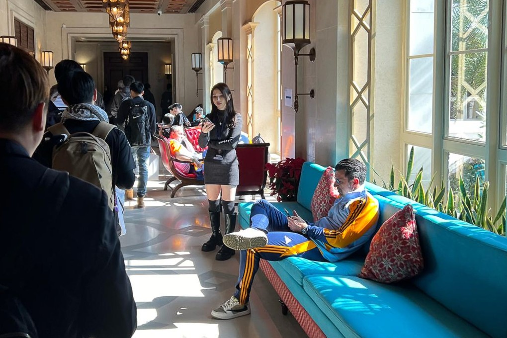 Real Madrid legend Luis Figo sits on a sofa at the Hong Kong Golf and Tennis Academy, while fans hoping to get players’ autographs queue in the corridor. Photo: Handout