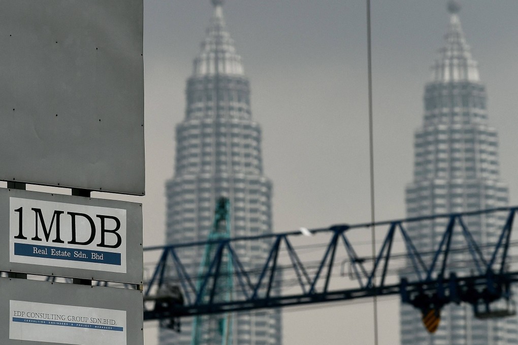 The 1MDB logo is seen on a billboard at the funds flagship Tun Razak Exchange under-development site in Kuala Lumpur. Photo: AFP