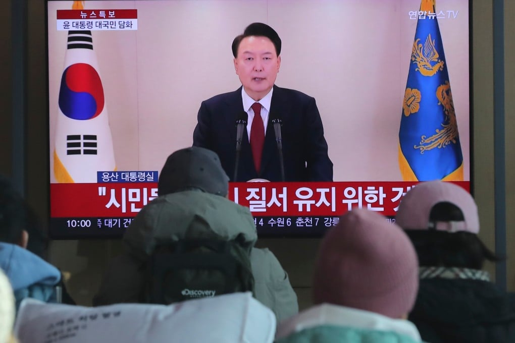 People watch a televised address by South Korean President Yoon Suk-yeol at Seoul Railway Station in Seoul on December 12. Photo: Xinhua