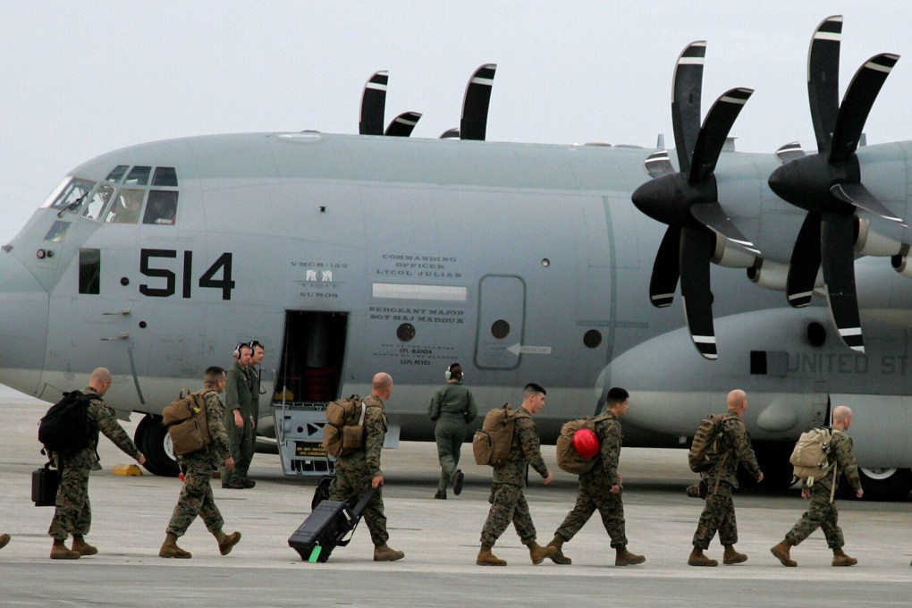 Japan-based US Marine Corps soldiers embark an aircraft in Ginowan, Okinawa Prefecture, southern Japan, in November 2013. Photo: EPA