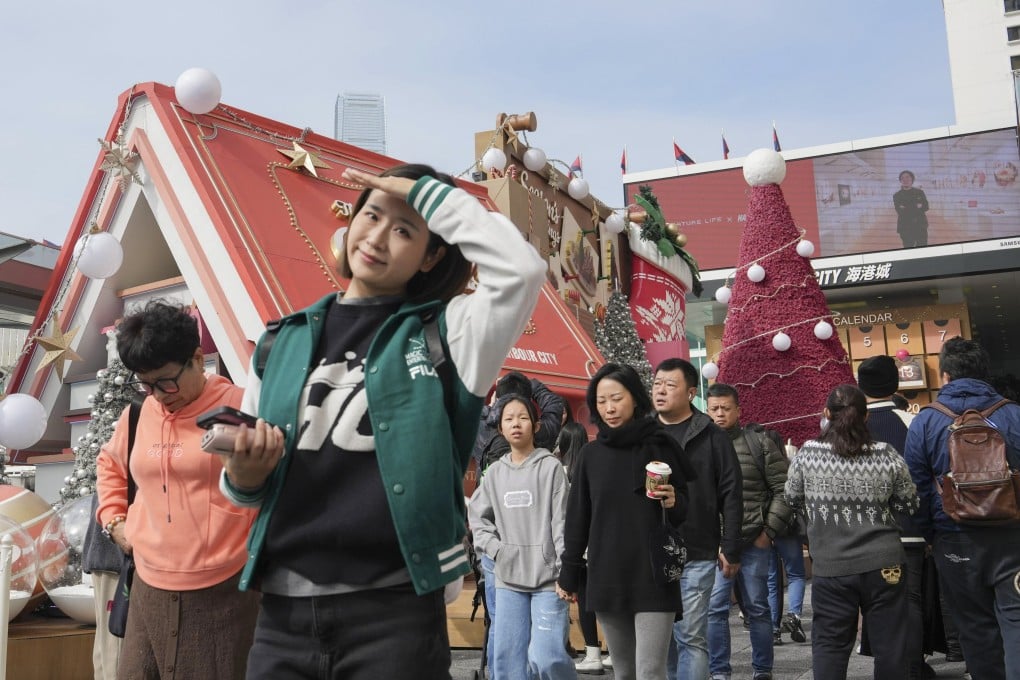 Visitors outside a shopping centre in Tsim Sha Tsui on Christmas Eve. Photo: Sun Yeung
