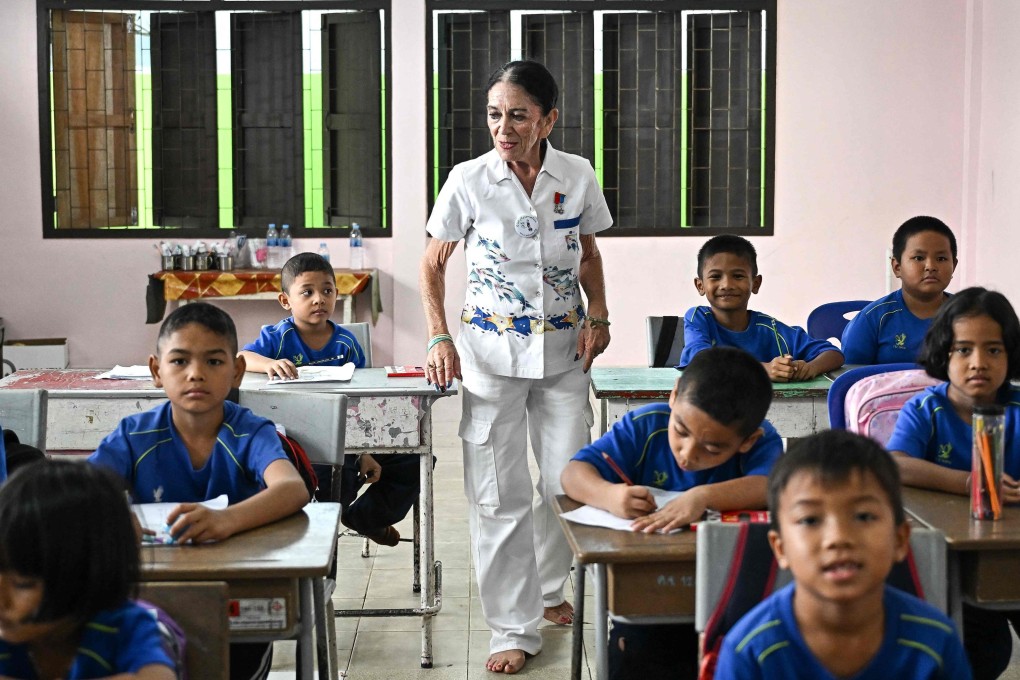 After her daughter died during Boxing Day tsunami, Elisabeth Zana (pictured here in a class) considered killing herself Then, she decided to help save a Thai school and, 20 years on, is still helping. Photo: AFP