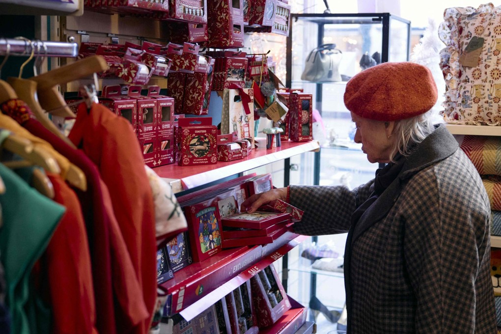 A customer browses second-hand items inside an Oxfam charity shop in London. This Christmas, more people than ever are buying “preloved” gifts from charity shops and online second-hand retailers. Photo: AFP