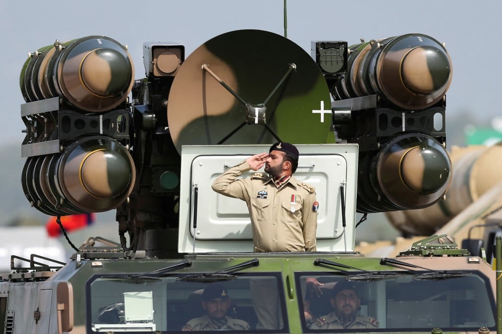 A Pakistani soldier salutes while standing on an air defence missile system during Pakistan Day military parade in Islamabad in 2022. Photo: Reuters