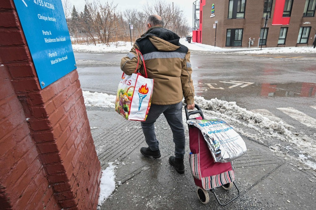 People carry bags of food after visiting the Welcome Hall Mission grocery service for those experiencing food insecurity in Montreal on December 19. A report by food rescue organisation Second Harvest found 21.18 tonnes, or 46.5 per cent of all food produced in Canada, is wasted every year. That ranks Canada among the most wasteful countries in the world. Photo: AFP