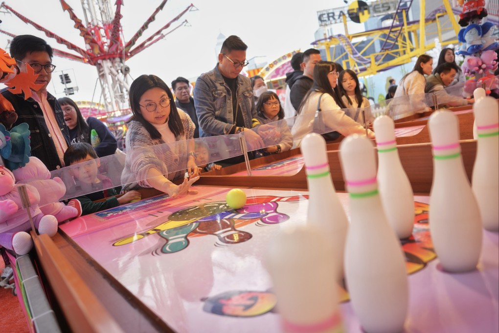 People play booth games at the AIA Carnival, at the Central Harbourfront Event Space, on December 22, 2024. Photo: Elson Li