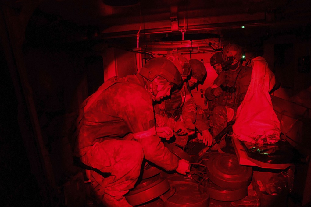 Ukrainian soldiers load anti-tank mines into an armoured vehicle in the Donetsk region on December 25. Photo: AP
