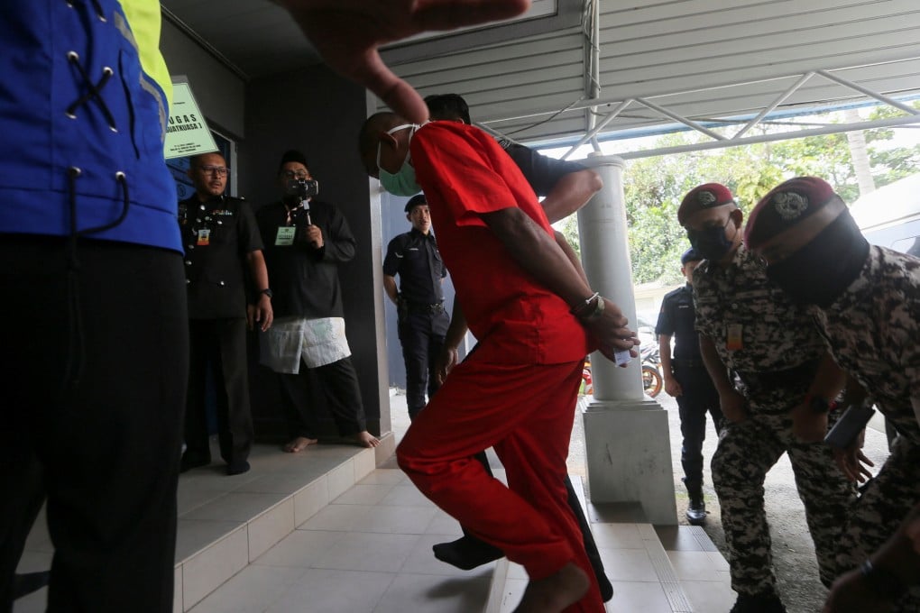 Mohd Affendi Awang, a 42-year-old father of five is escorted by a prison guard to face a public caning at a mosque, after being repeatedly convicted of the Islamic crime of ‘khalwat’, or close proximity between unmarried couples, at Kuala Terengganu, Malaysia on December 27. Photo: Reuters