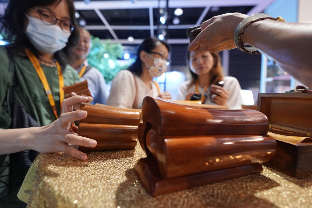 Visitors look at miniature coffins at Asia Funeral and Cemetery Expo and Conference at the Convention and Exhibition Centre in Wan Chai on May 7. Photo: Eugene Lee