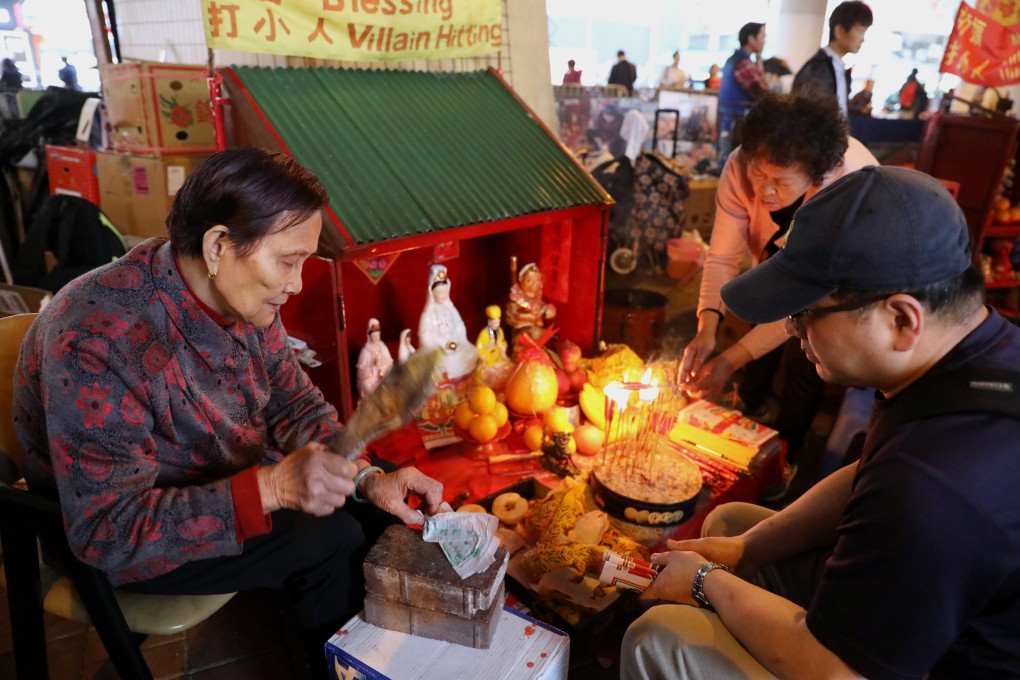 One of the “villain hitters” who operate under a flyover in Hong Kong performs a ritual. They practise a form of witchcraft, belief in which remains strong in the modern age in many parts of the world, as it has for thousands of years. Photo: Dickson Lee