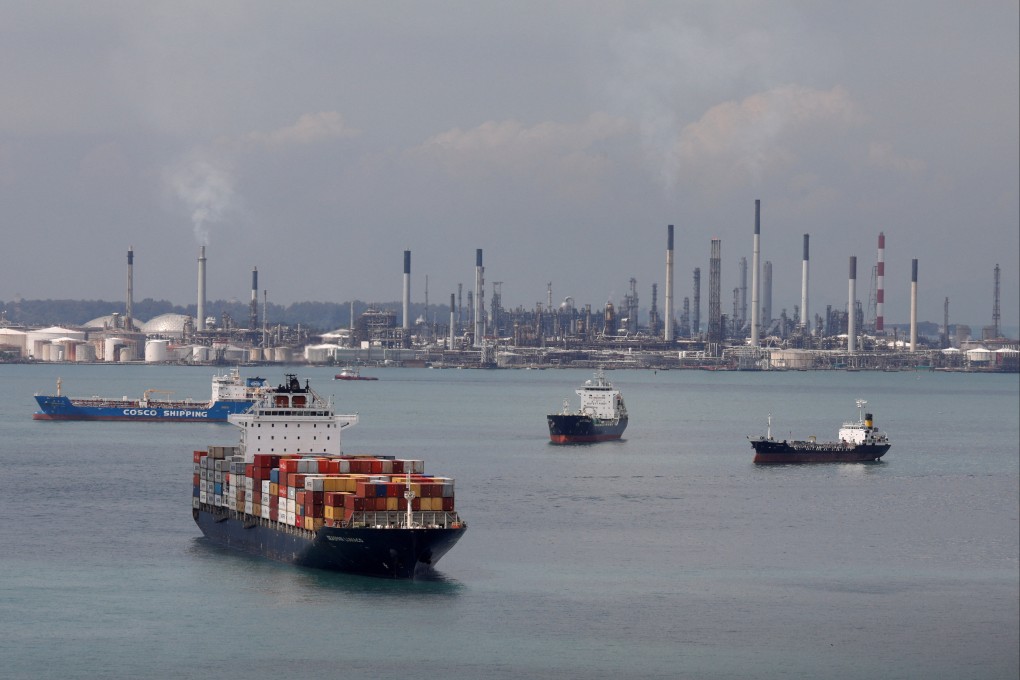 A container ship passes Shell’s Pulau Bukom refinery in Singapore. Photo: Reuters