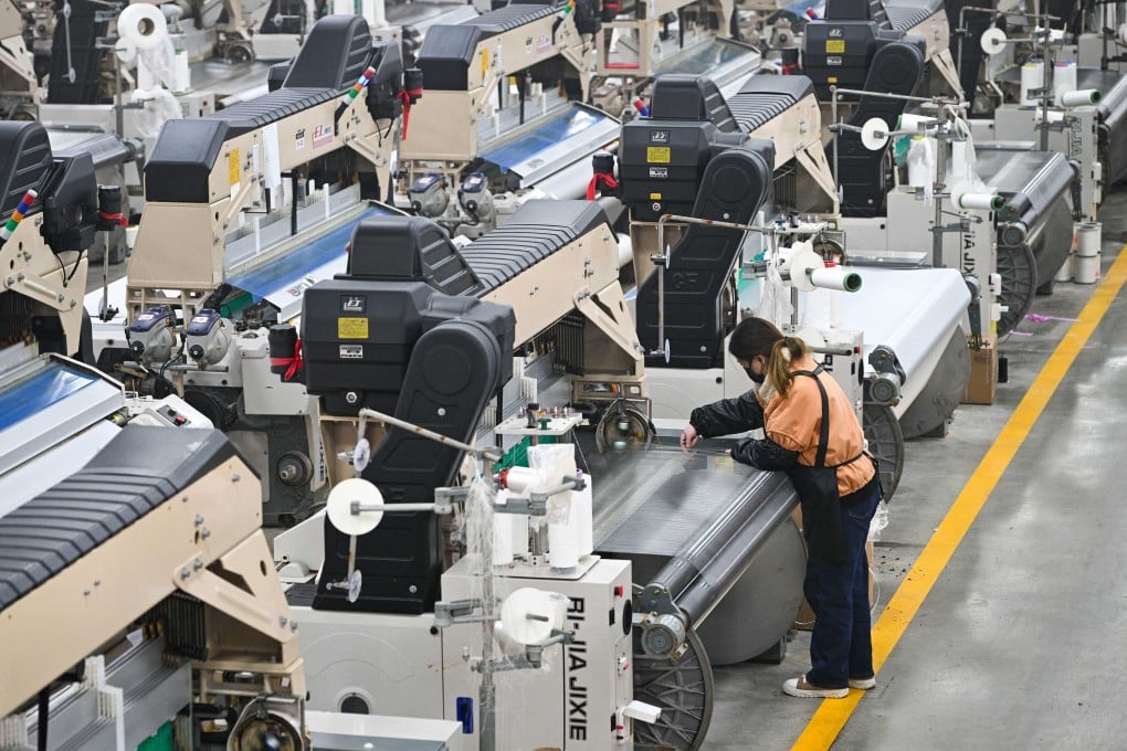 A woman works at a texile factory in Siyang county, Jiangsu province, on Tuesday. Photo: AFP