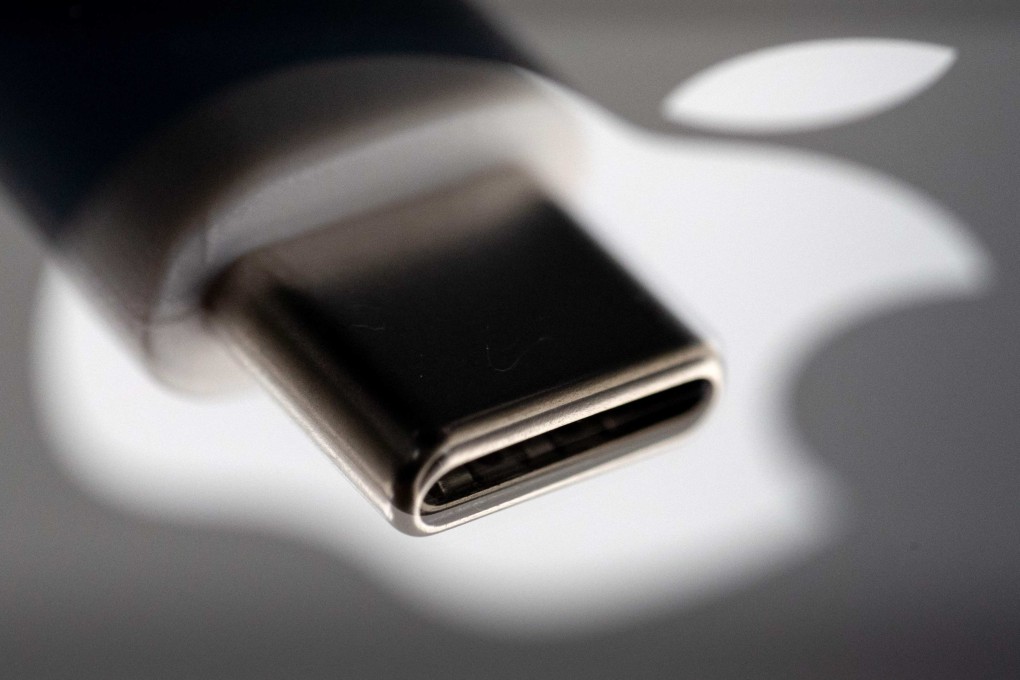A USB-C plug reflected on the Apple logo. Photo: AFP