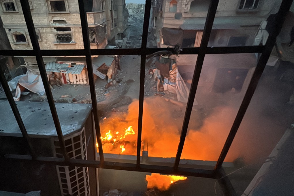 A fire seen through a window from Kamal Adwan Hospital in northern Gaza. On Friday, Gaza’s health ministry said Israeli troops forcibly removed staff and patients from the hospital. Photo: Reuters