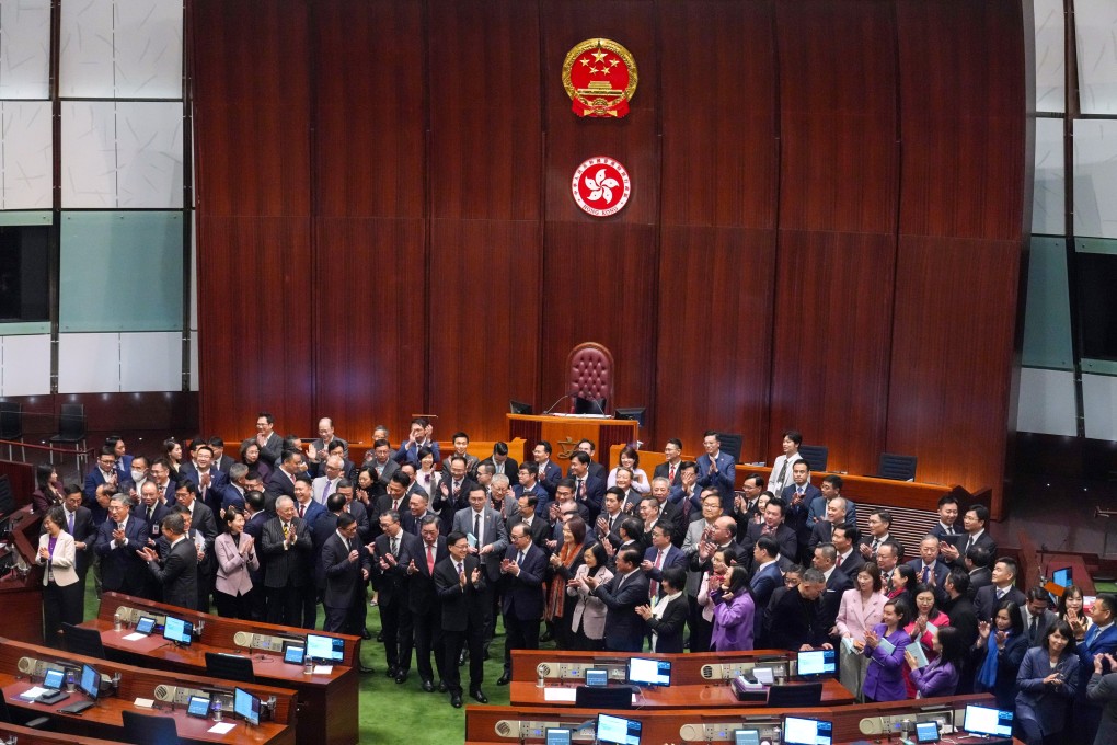 Hong Kong leader John Lee and lawmakers gather for pictures after the vote on domestic national security legislation at the Legislative Council. Photo: Sam Tsang
