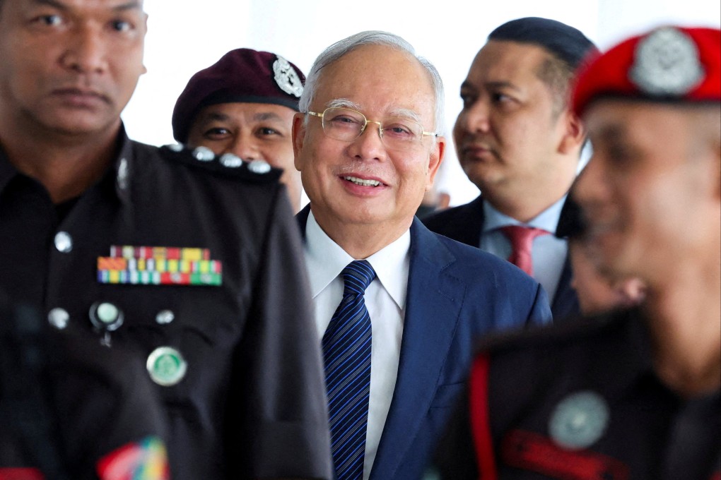 Former Malaysian prime minister Najib Razak being escorted during a break in court proceedings in Kuala Lumpur in April. Photo: Reuters