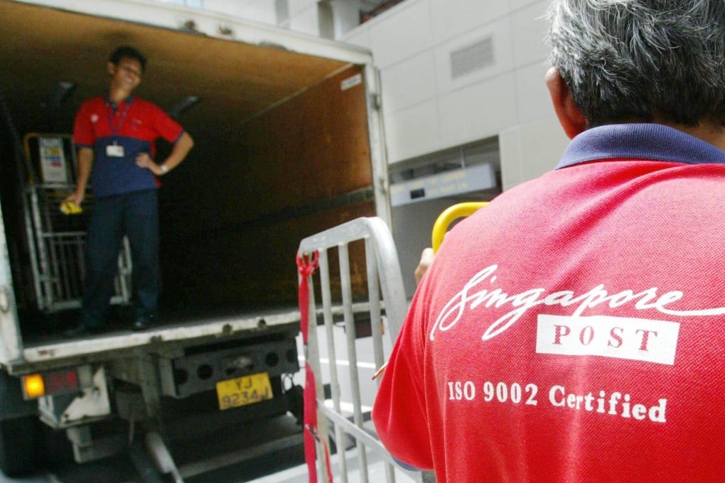 A SingPost worker prepares to load parcels and letters on a lorry in Singapore. Photo: AFP