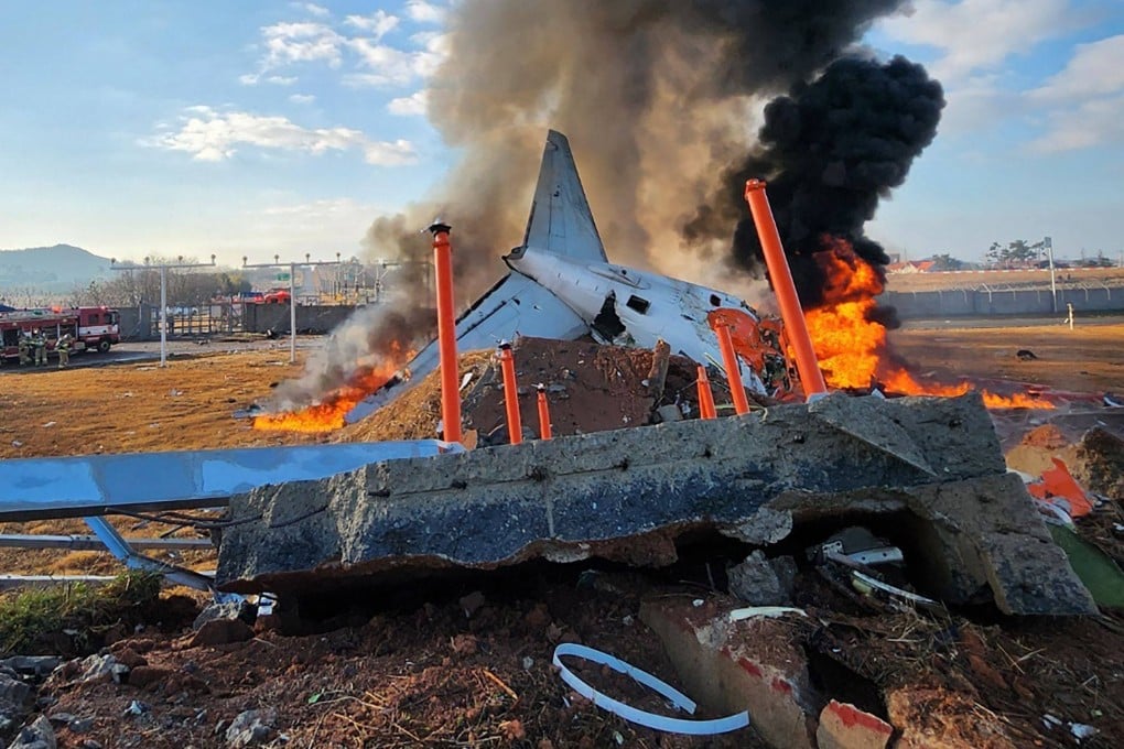 Fire and smoke rise from the tail section of a Jeju Air Boeing 737-800 series aircraft after the plane crashed and burst into flames at Muan International Airport. Photo: Yonhap/AFP