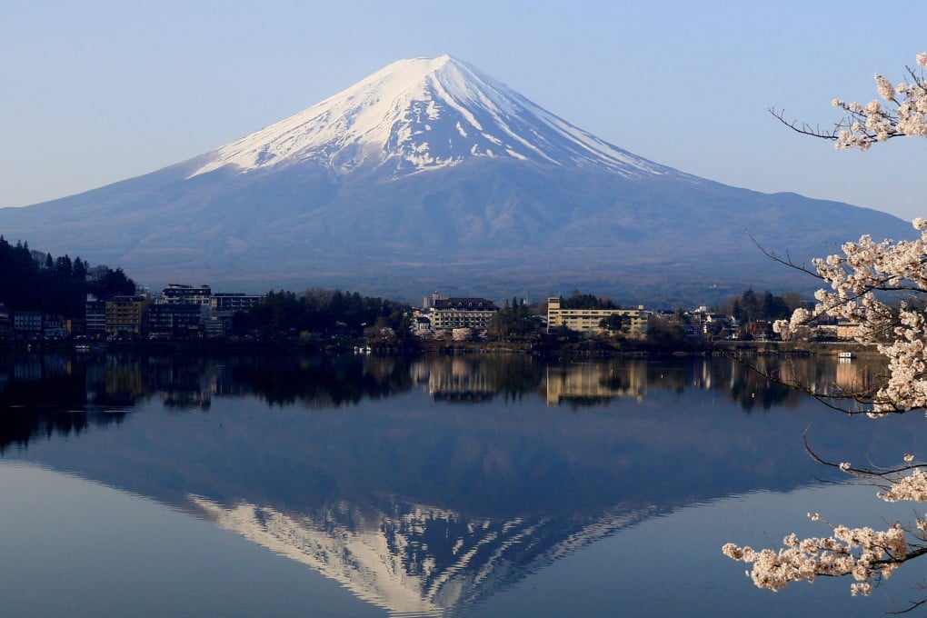 Cherry blossom trees with Mount Fuji in the background at Lake Kawaguchiko, Fujikawaguchiko, Japan. Photo: Reuters