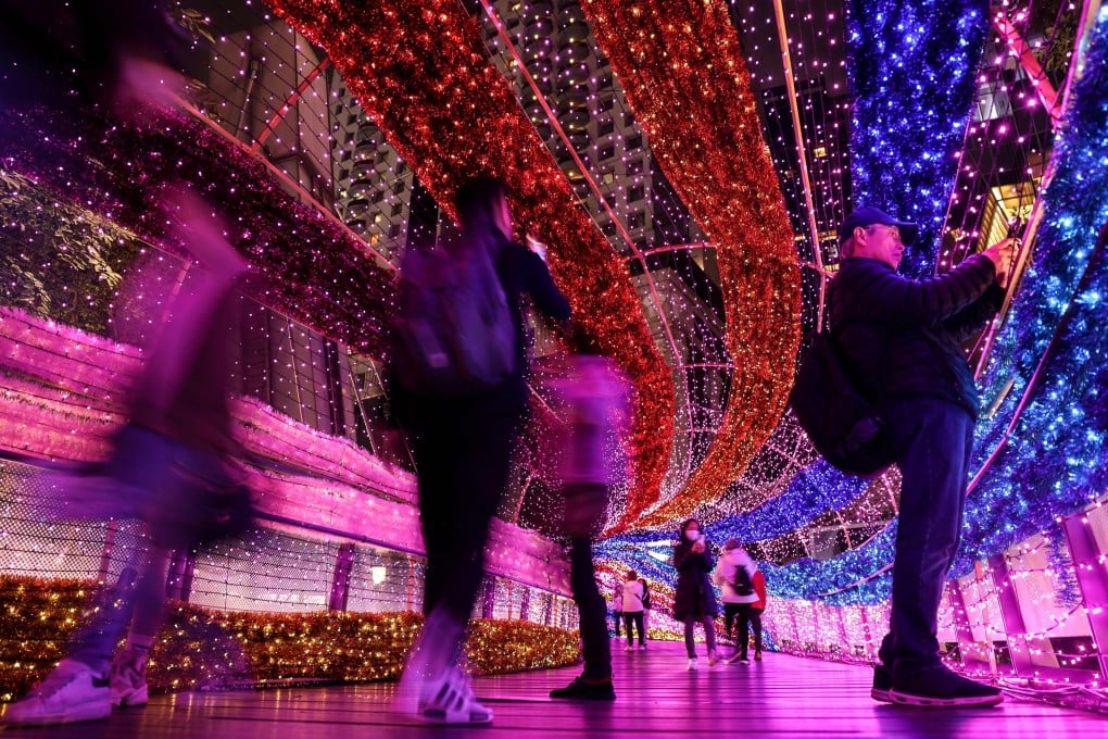 Visitors walk through a festive light tunnel in New Taipei City on Christmas Eve. From January 1, Taiwan will be issuing six-month visas to “digital nomads” to lure more foreigners to the island. Photo: AFP