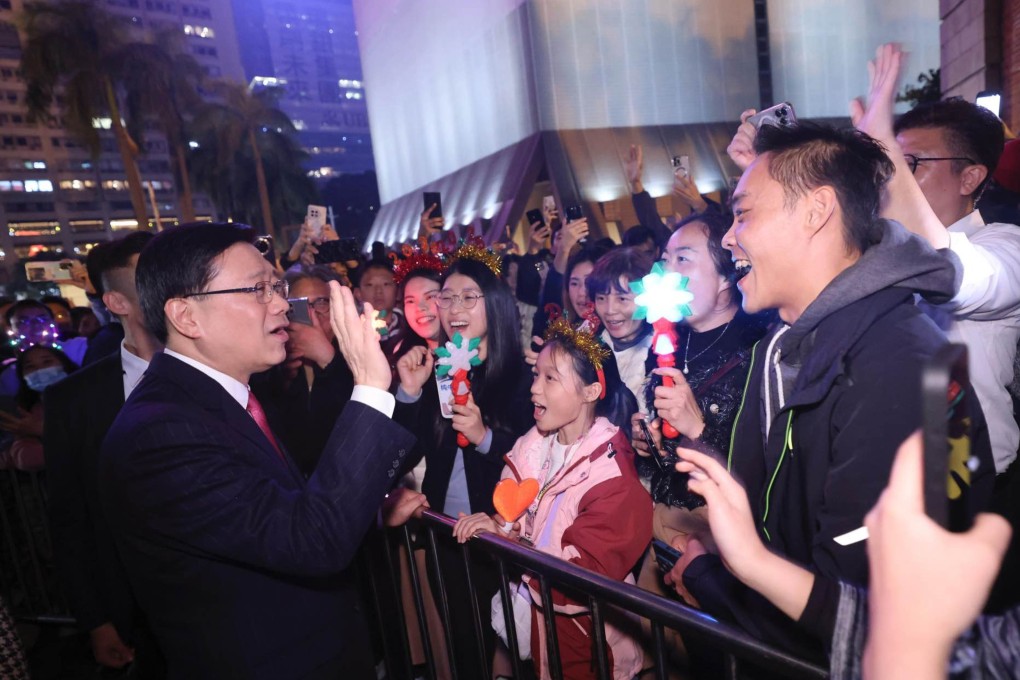 Chief Executive John Lee (left) meets revellers amid New Year celebrations. Photo: Facebook/John Lee