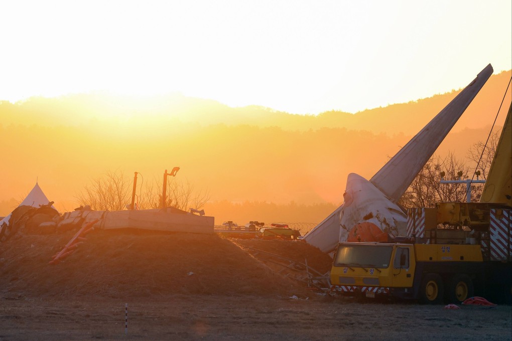 The sun rises over the scene where a Jeju Air plane crashed in South Korea’s Muan. Photo: Yonhap/AFP