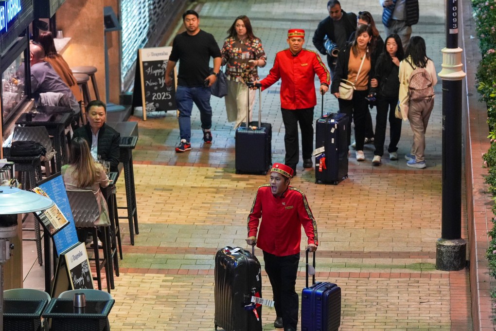 Hotel porters in Tsim Sha Tsui help patrons with their luggage. Photo: Eugene Lee